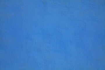 Dark-blue or sapphirine wall, texture, background. The building wall, painted with water-based paint. Smooth (flat) surface in blue color with a little stains or dust. Bluish backdrop - obrazy, fototapety, plakaty