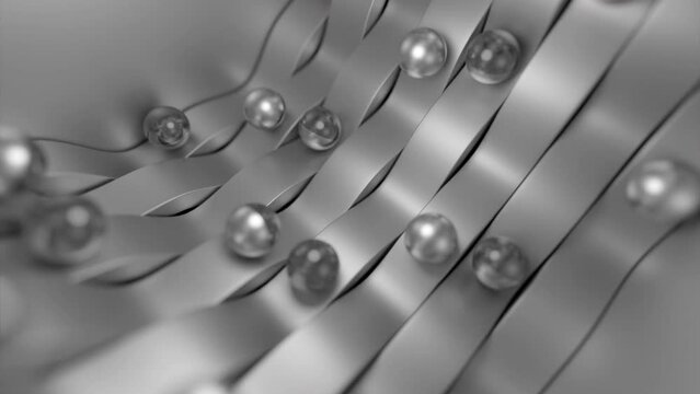 Bended silver ribbons with rolling metal balls. Design. Metal glowing pearls in motion.