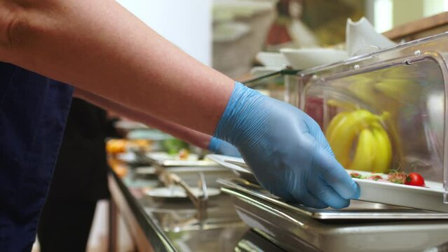 The chef prepares food for the arrival of guests at a restaurant or hotel buffet. Delicious, healthy dishes are prepared for lunch.
