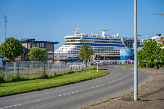 Aida Bella at the Port of Invergordon, Scotland during sunny day, side view from the distance