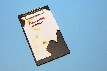 fire risk assessment form on a clipboard. - obrazy, fototapety, plakaty