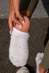 women rubbing the heel of her foot under her sock