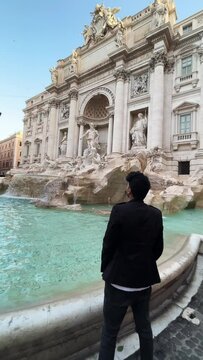 tourist in the trevi's fontain in rome italy