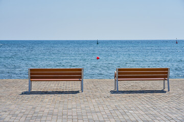 Benches on the embankment against the backdrop of the Mediterranean Sea.