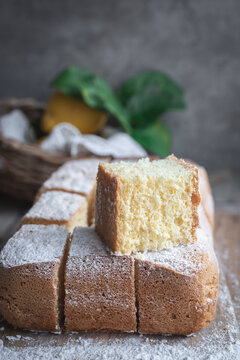 Pasiego cake sprinkled with sugar on rustic wooden table