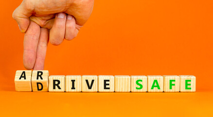 Drive and arrive safe symbol. Concept words Drive safe Arrive safe on wooden blocks. Beautiful orange table orange background. Businessman hand. Business drive and arrive safe concept. Copy space.