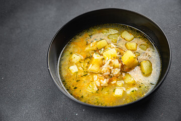 vegetables soup with rice broth, potatoes, carrots, onions healthy eating cooking appetizer meal food snack on the table copy space food