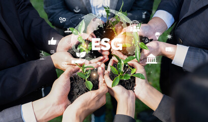 Business partnership leader gather to nurture young seedling plant with ESG icons, symbolizing...