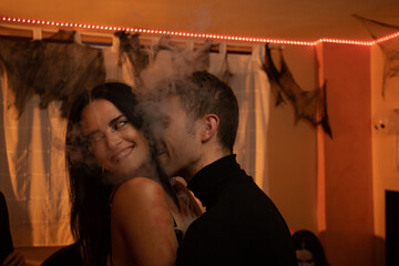 European Halloween party in a friends apartment- -Images of Young adults celebrating Halloween. The bride and groom during the Halloween party