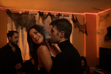 European Halloween party in a friends apartment- -Images of Young adults celebrating Halloween. The...