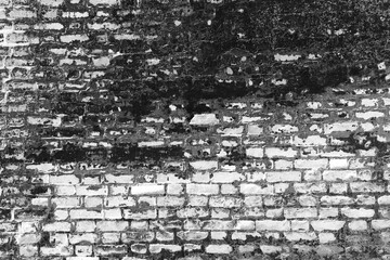 An old shabby black brick wall