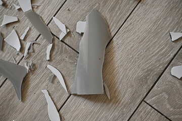 glass shards on the floor as a backdrop, broken dishes grey as a backdrop