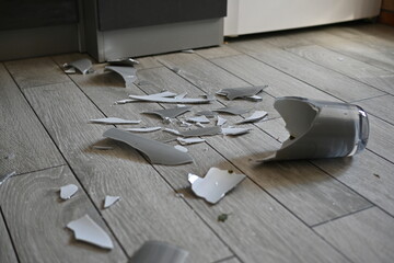 gray broken vase, vase shards on the floor, broken vase on the kitchen floor, 
