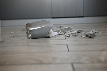 gray broken vase, vase shards on the floor, broken vase on the kitchen floor, 