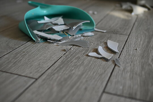 Collected glass in a dustpan close-up, broken vase collected in a dustpan - Powered by Adobe