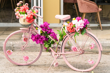 Classic pink bicycle decorated with flowers.