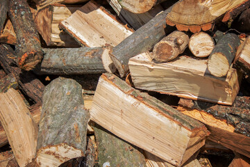 Wall of firewood, background of dry chopped firewood. Wooden background. Natural texture.