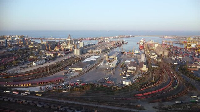 High angle aerial footage of a train terminal at an European port. Drone video in 4k of trains and train cars with cargo and containers ready to be unloaded at the black sea port of Constanta.