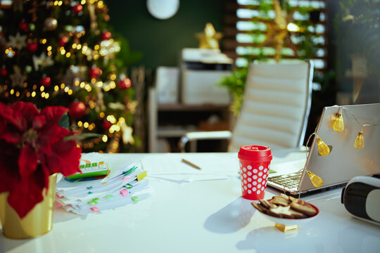 modern Christmas decorated green office with laptop