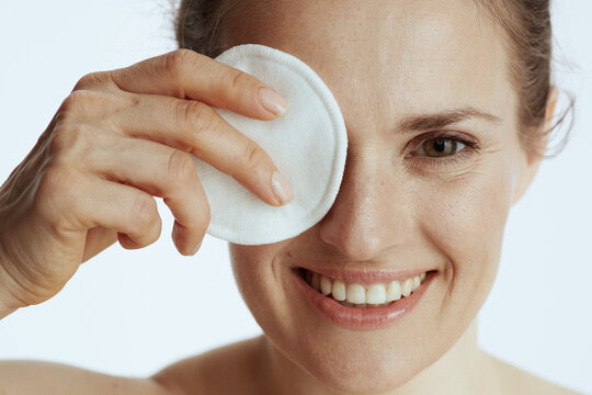 happy young woman with cotton pad on white