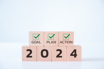 Wooden cubes with 2024 and goal, plan, action icon on white background. 2024 goals of business or...