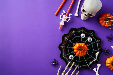 Halloween party decorations on purple background. Flat lay, top view.