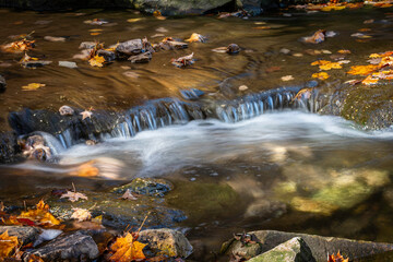 small cascade waterfall in fall foliage