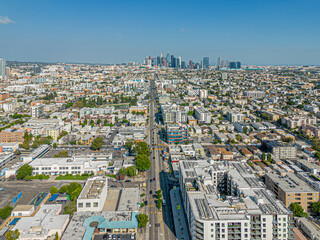 Los Angeles, California – September 19, 2023: aerial drone view toward LA Koreatown with Olympic Blvd and LA downtown including apartments, condominiums, houses, buildings at sunny day 