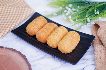 Fried croquettes on a black plate. Selective focus.