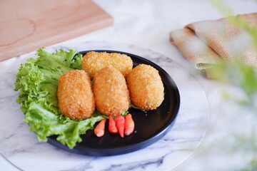 Fried croquettes on a black plate. Selective focus.