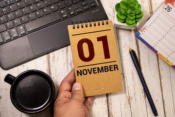 November 1st. Image of november 1 wooden color calendar on white brick wall background. empty space...