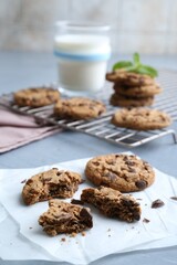 Tasty chocolate chip cookies on light grey table