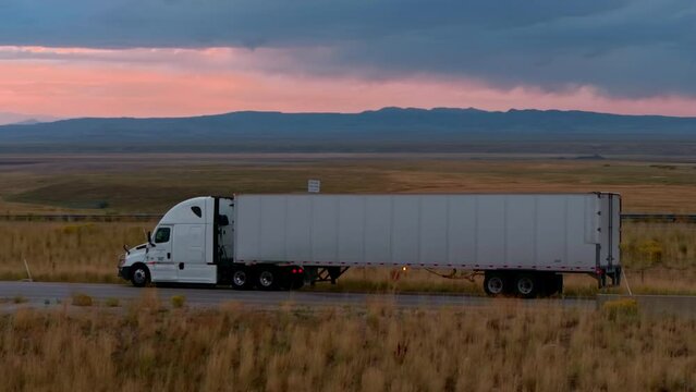 Sunset Drive: Semi Truck in Desert Steppe Standing on the road.