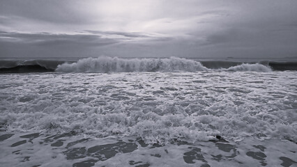 Wild waves and foam in motion from the ocean at beach on a tropical island. 
