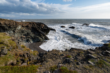 Fototapeta na wymiar Stormy seas on rugged east coast of Iceland with strong winds on sunny autumn morning.
