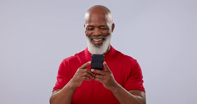 Phone, smile and social media with a senior black man in studio on a gray background for communication. Contact, funny and an elderly person laughing at a comic, meme or internet post on his mobile