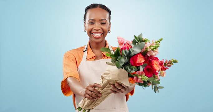 Smile, florist and black woman with gift of flowers in studio isolated on a blue background mockup. Portrait, bouquet and giving floral present, roses or plants in small business shop of entrepreneur