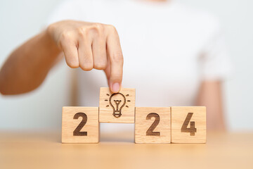 2024 block with lightbulb. Business Idea, Creative, Thinking, brainstorm, Goal, Resolution,...