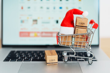 Christmas Online Shopping concept. Boxes with shopping cart on a laptop computer. Sale and discount...