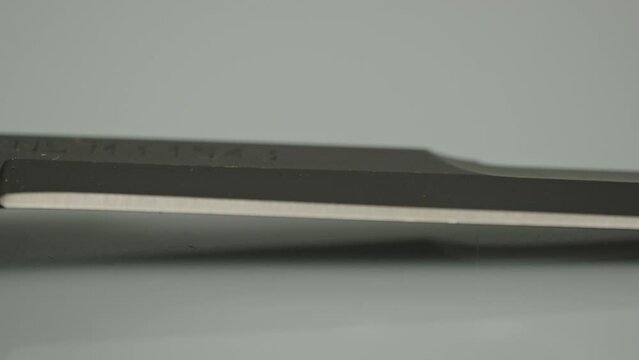 Focus rack from engraving on knife to sharp edge of combat blade