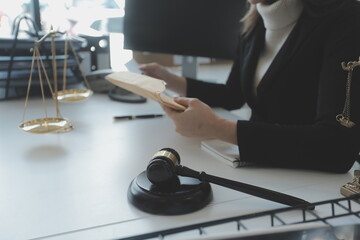 Male lawyer working with contract papers and wooden gavel on tabel in courtroom. justice and law ,attorney, court judge, concept.