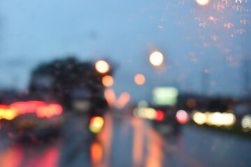 traffic jam on the road in night with rain, defocused background - obrazy, fototapety, plakaty
