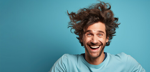 Vibrant Portrait of a Cheerful Guy with Exceptionally Voluminous Hair, Perfect for Shampoo Advertisement