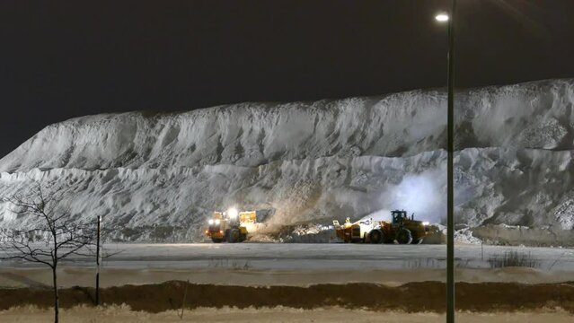 Snowplows dumping snow during the worst snowfall in Montreal, Canada