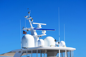 Radar and communication tower on a yacht. The mast of a large yacht with navigation equipment....