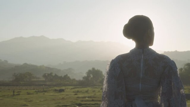 Woman In Verdant Field Bathed In First Light