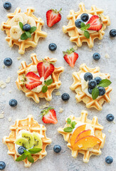 Freshly baked waffles with strawberries and blueberries