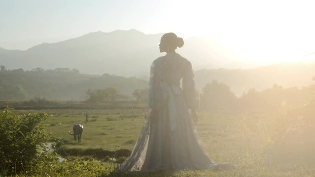 Elegant Woman In A Dress On A Field At Sunrise