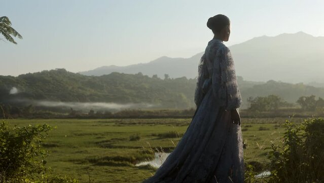 Lady Watching Grazing Water Buffaloes At Sunrise
