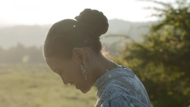 A Woman Smiling Widely In Soft Sunlight